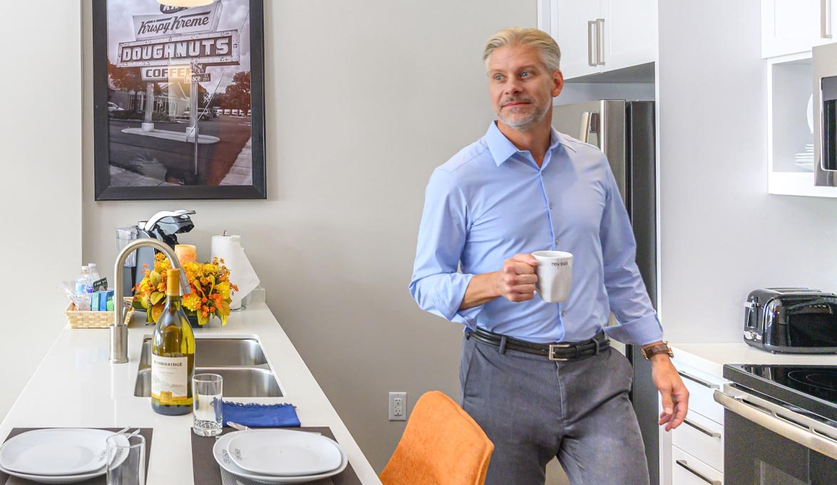 Man enjoying coffee in the kitchen.